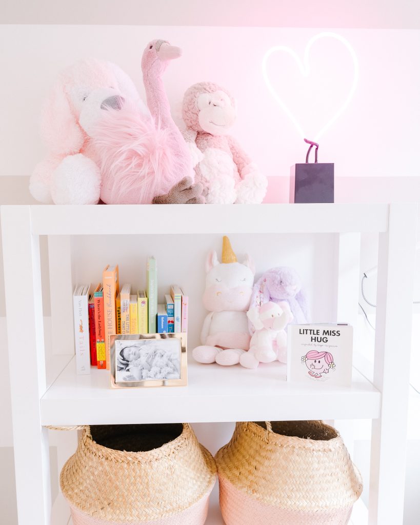 baby girls storage shelf with pink belly baskets and neon light